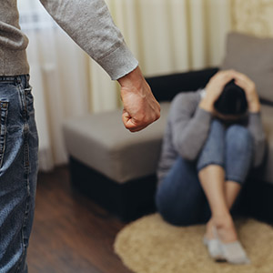 A man threatening a woman, representing domestic violence legal issues.